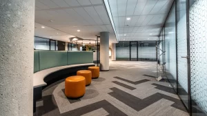 Ambiente comercial com forro modular e iluminação embutida, demonstrando soluções de forro para espaços comerciais contemporâneos.